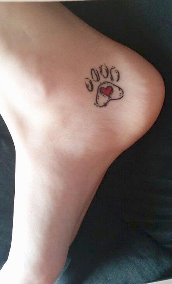 Paw print tattoo with little heart on foot.