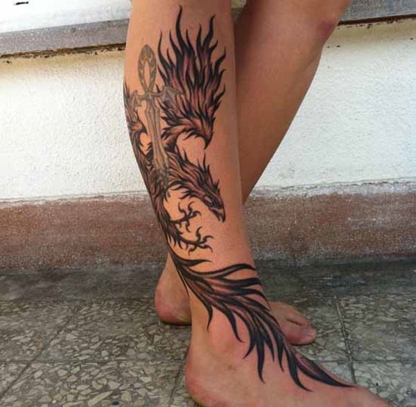 Placing a phoenix tattoo on the leg.