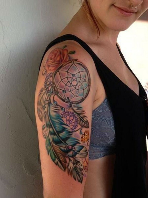Pretty dreamcatcher tattoo on upper arm.