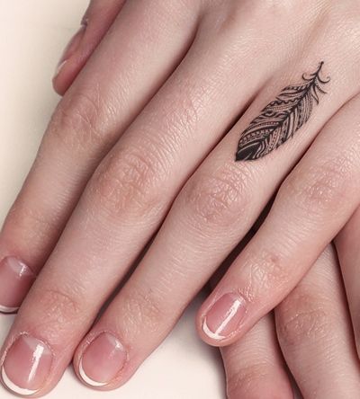 Ring finger feather tattoo.