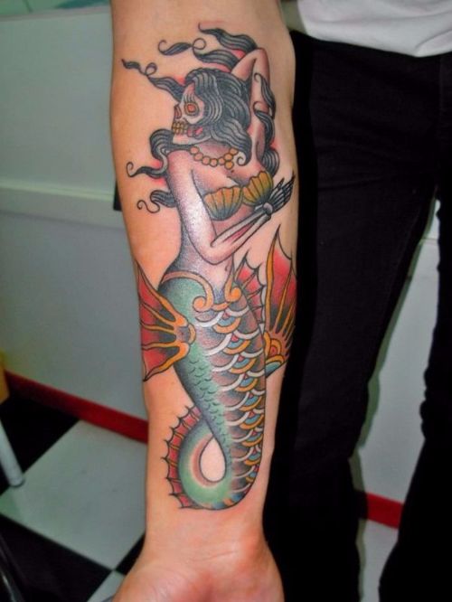 Skull mermaid forearm tattoo.