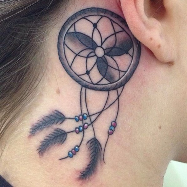 Small dreamcatcher tattoo behind the ear.