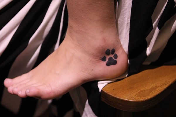 Small paw tattoo on ankle.