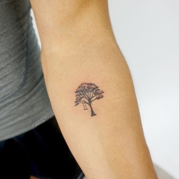 Small tree tattoo with hanging swing remind your childhood.