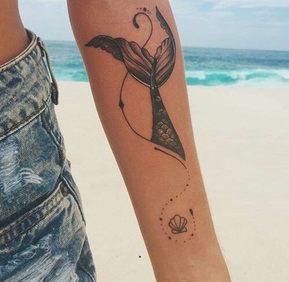 Tail, shell and waves mermaid tattoo.