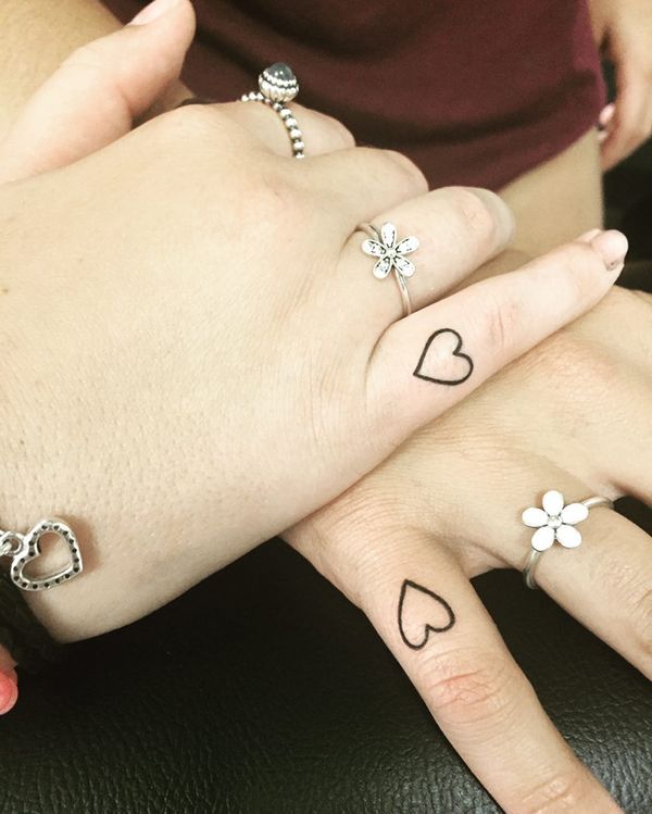 Teeny tiny heart tattoos for sweethearts.