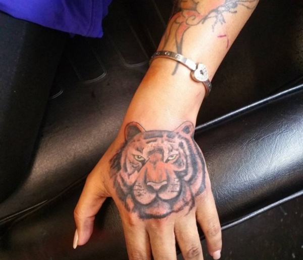 This angry looking tiger for your hand tattoo would be the best design.