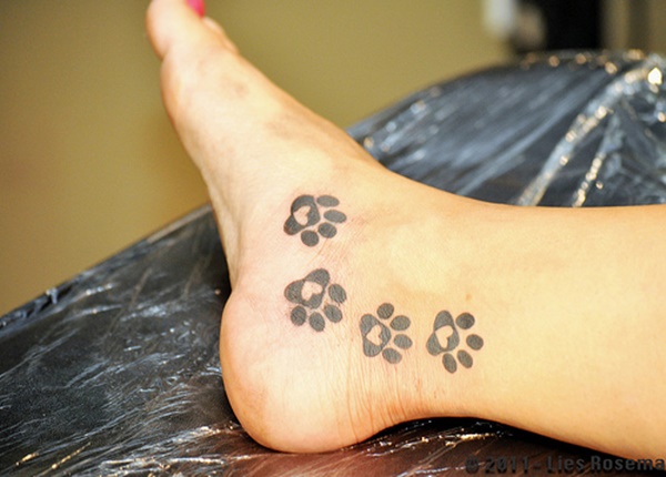 This dog paw tattoo is unique as you can see a heart on every paw print.