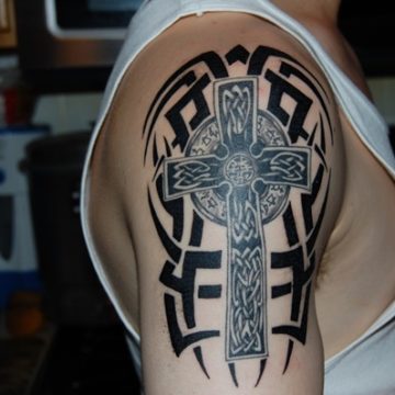 Tribal theme celtic tattoo combined with cross.