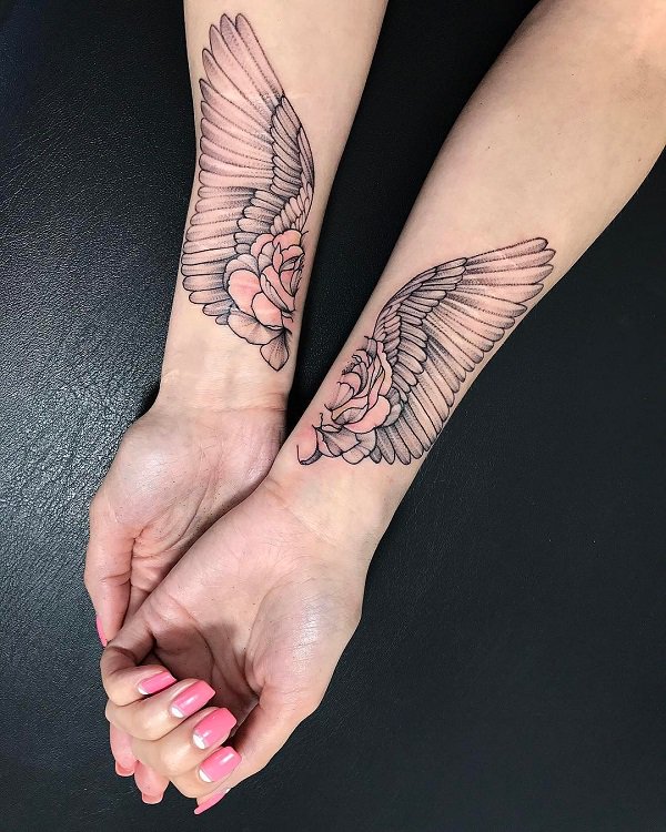 Wings With Flower Wrist Tattoo.
