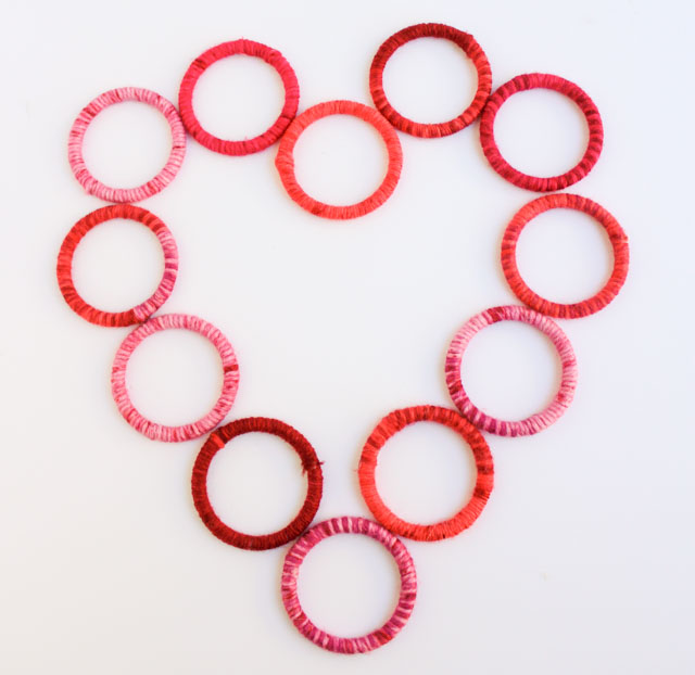 Awesome DIY yarn wrapped heart wreath.