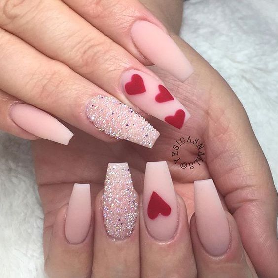 Fabulous nude nails with hearts and sparkle finger.