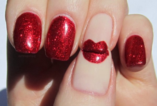 Glittery red kiss nails.