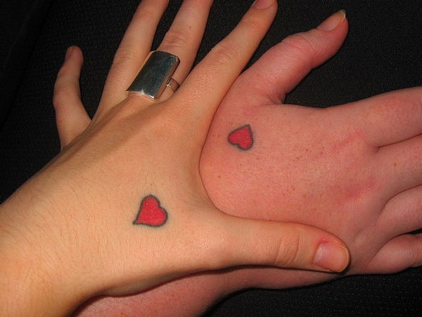Just simply heart tattoo on your hand that is how you can pour your feelings.