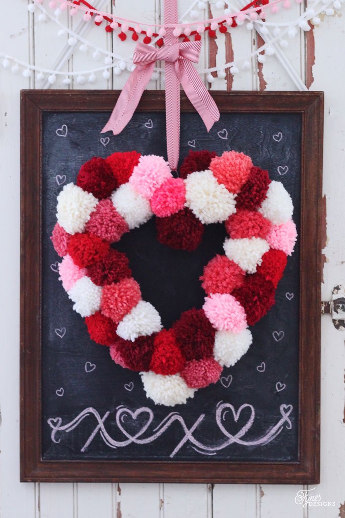 Multicolor heart shape pom pom wreath.