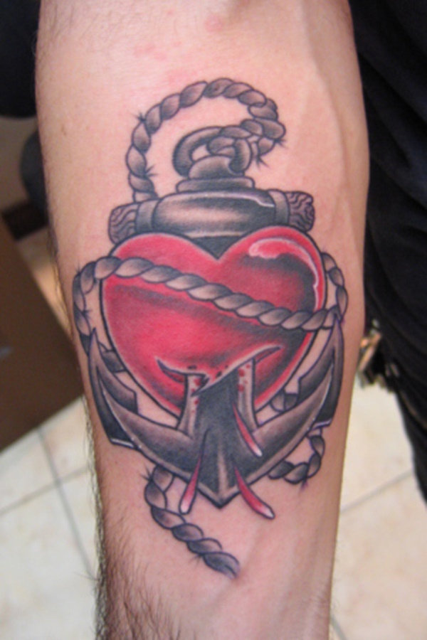 Ouch Blood red heart tattoo along with anchor penetrating it is enough to alive your passion forever.