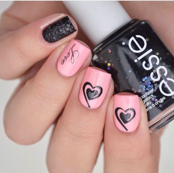 Pretty pink nails with stylish black heart.