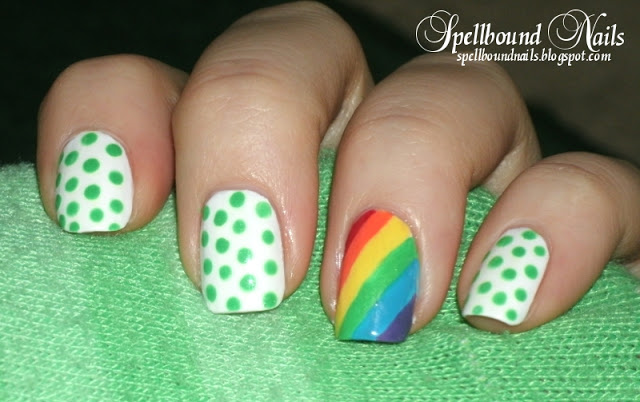 A green and white polka-dot design with a rainbow statement nail for extra good luck.