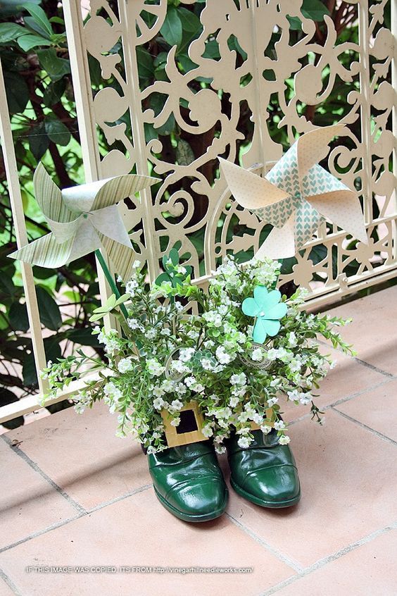 Green shoes used as flower vase for balcony decoration.