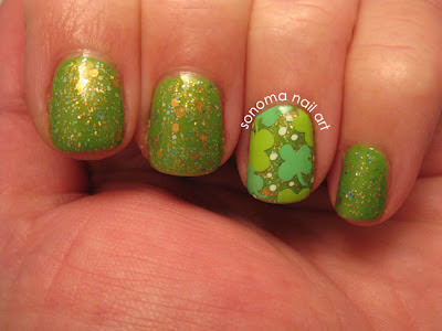 Sparkly green nails with little four-leaf clover.
