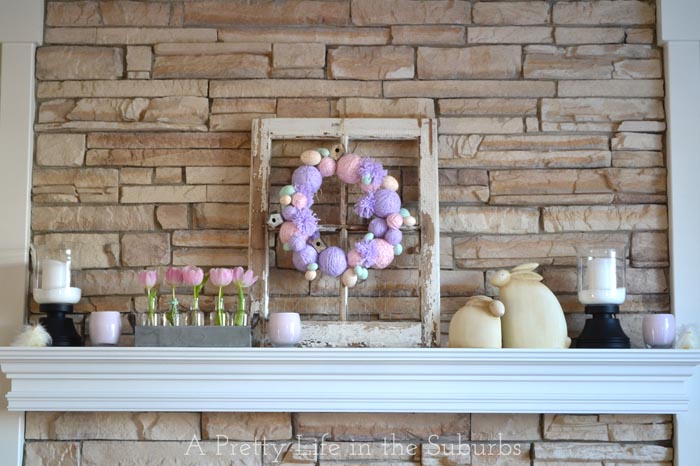 Amazing yarn ball garland with pink tulips for mantel decor.