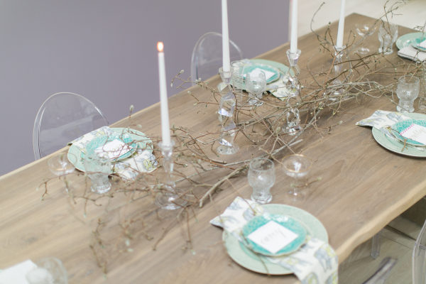 Awesome table decor with magnolia branches, tall candlesticks and personalized, embroidered place cards.