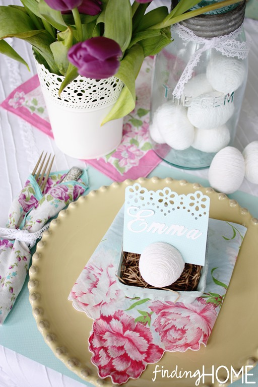 Pretty Easter table setting with yarn eggs.