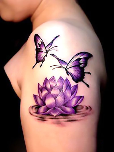 3D lotus flower and butterfly tattoo on upper arm.