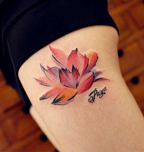 Abstract watercolor lotus thigh tattoo.