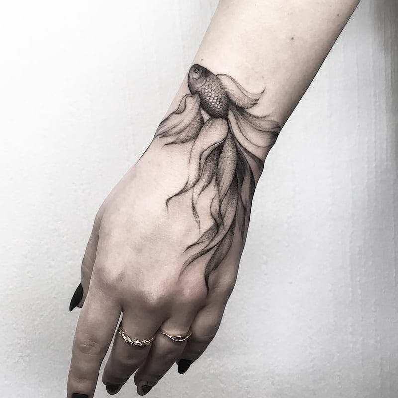 Amazing fish tattoo on wrist.