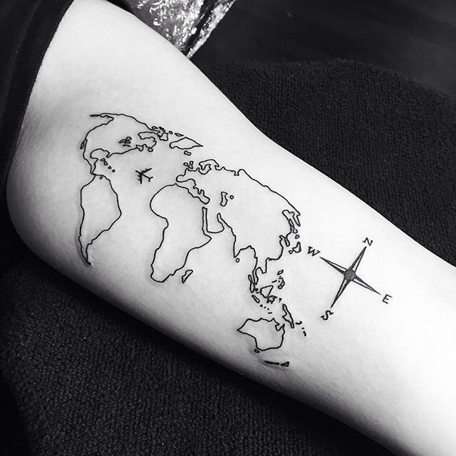 Amazing travel tattoo includes a compass and an airliner making the long flight across the Atlantic ocean.
