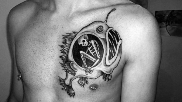 Angler fish tattoo on chest.