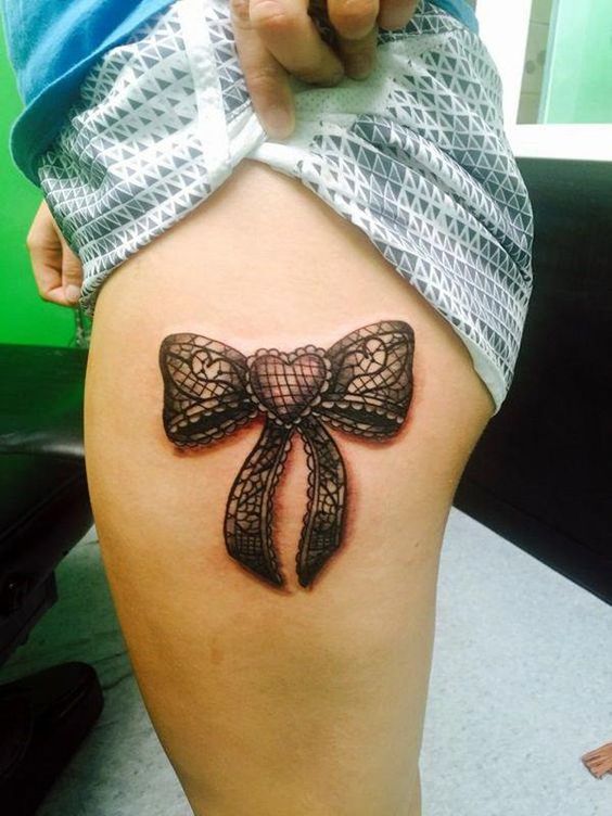 Attractive lace bow tattoo on upper thigh.