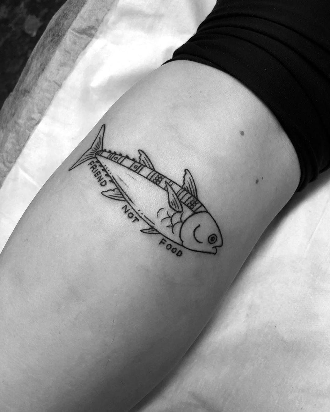 Black fish tattoo with beautiful message.