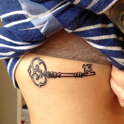 Black ink key tattoo design for side rib.