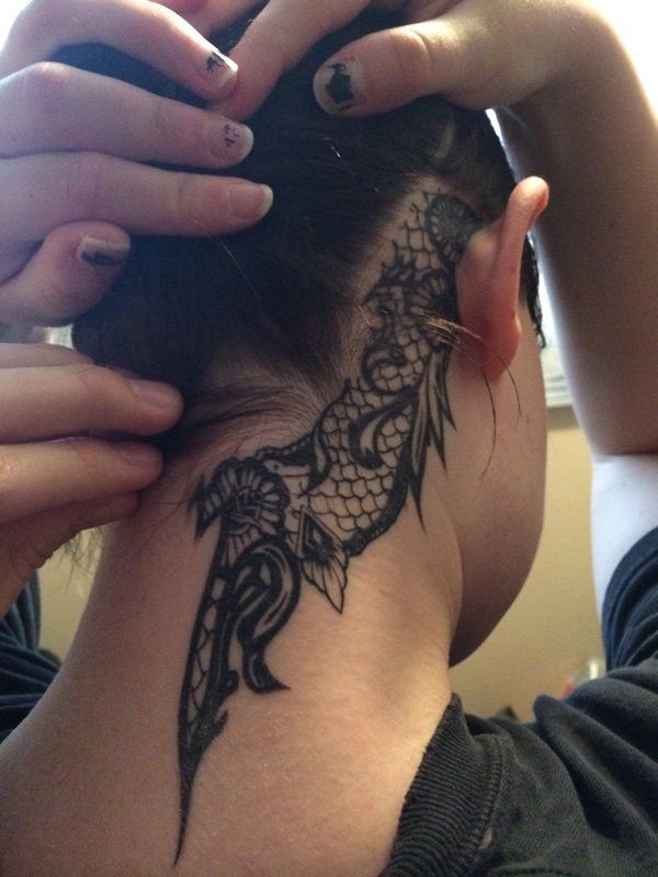 Charming lace tattoo behind the ear.