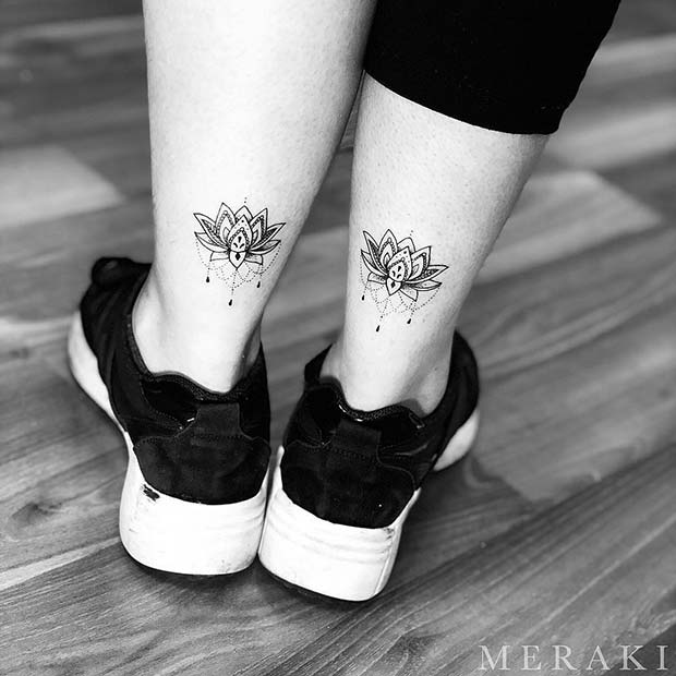 Charming matching lotus flower foot tattoo.