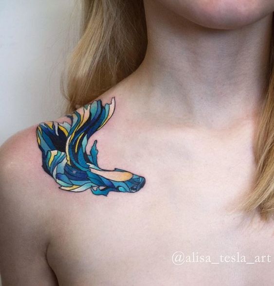 Contemporary fish tattoo on shoulder.
