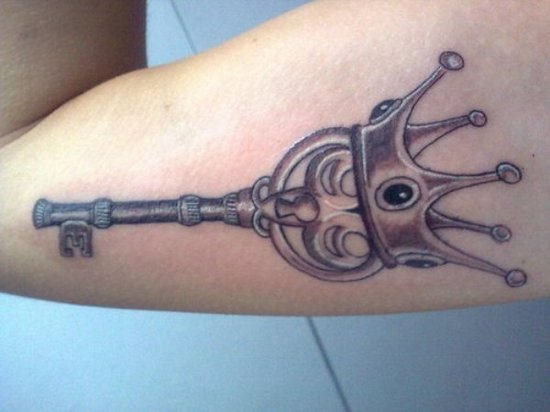 Crown key tattoo on muscle.