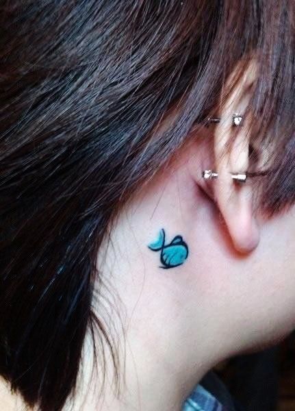 Dashing blue tiny fish tattoo behind the ear.