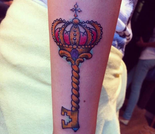 Elegant key tattoo with tiara.