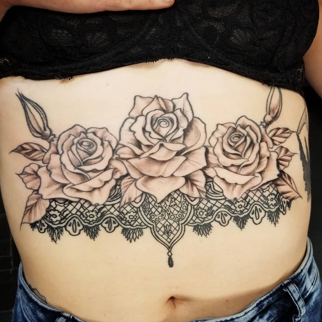 Feminine lace tattoo with roses.