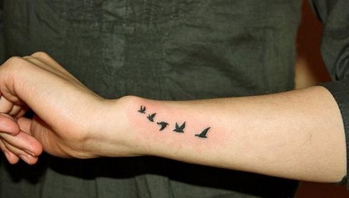 Flying birds wrist tattoo.