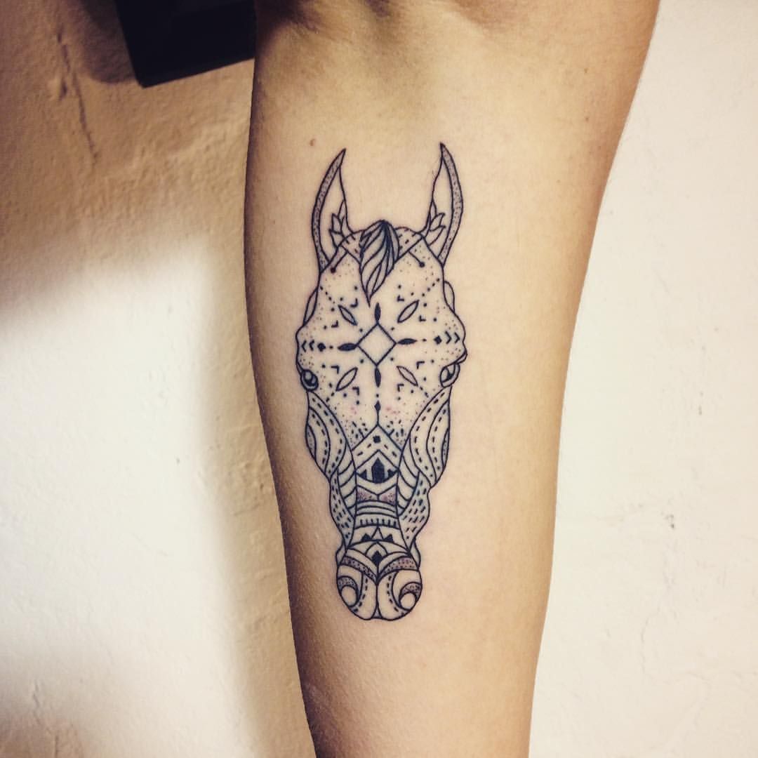 Geometric horse tattoo on arm.