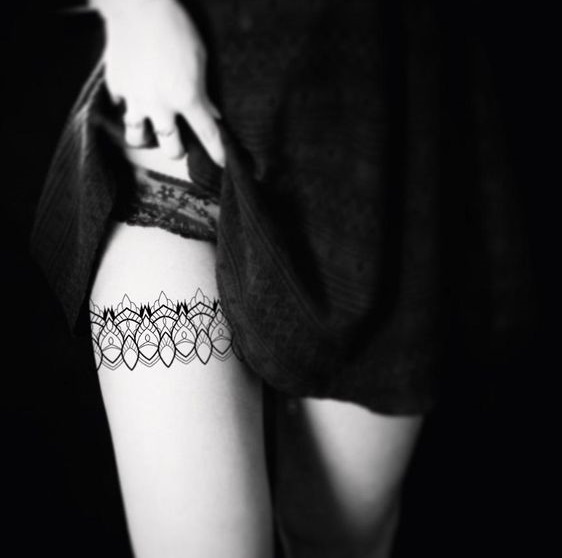 Geometric lace tattoo on thigh.