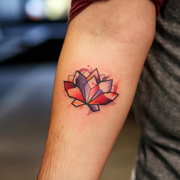 Geometric watercolor forearm lotus flower tattoo.