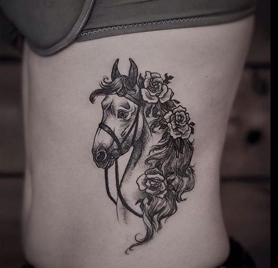 Girls can add flowers in their horse tattoo design and it will be charming.