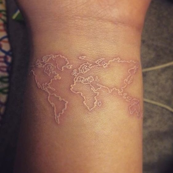 Gorgeous white world map tattoo on wrist.