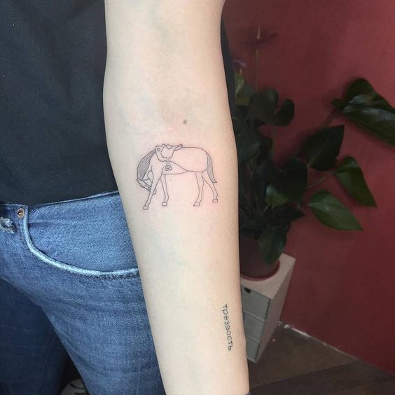 Graceful fine line horse tattoo on inner forearm.