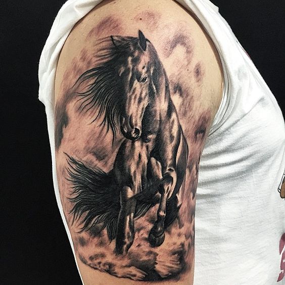 Grey upper arm horse tattoo.